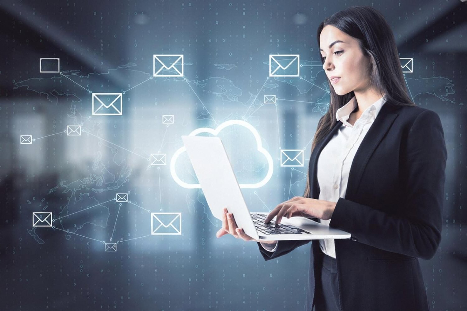 Business user working on a laptop with cloud and email icons floating around, showing partial Azure migration for a UAE company